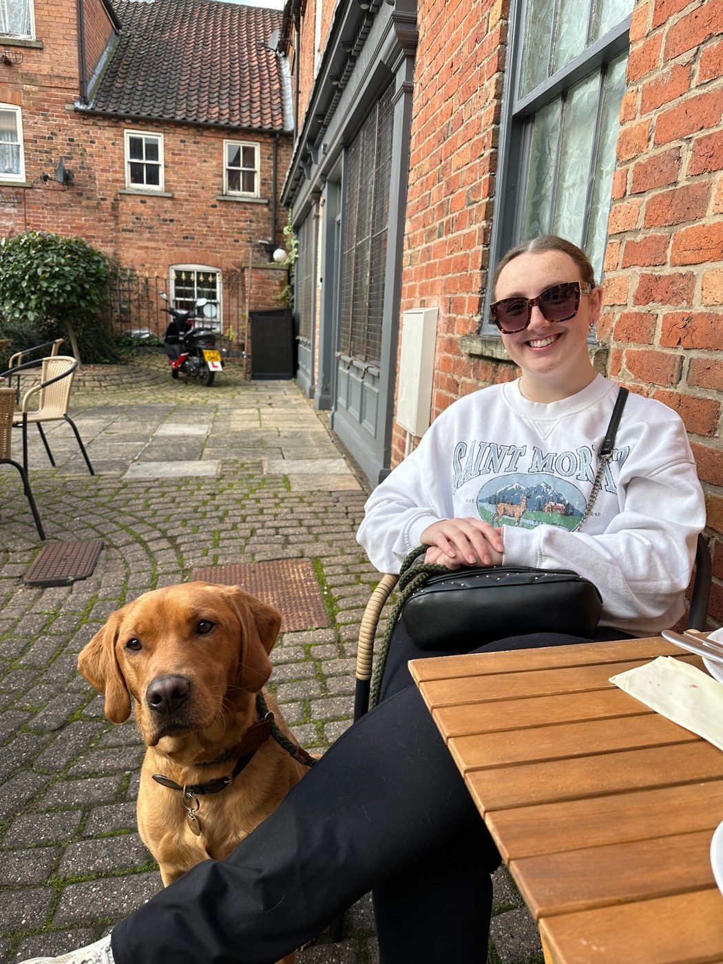 Lauren and her Labrador Amber at a café